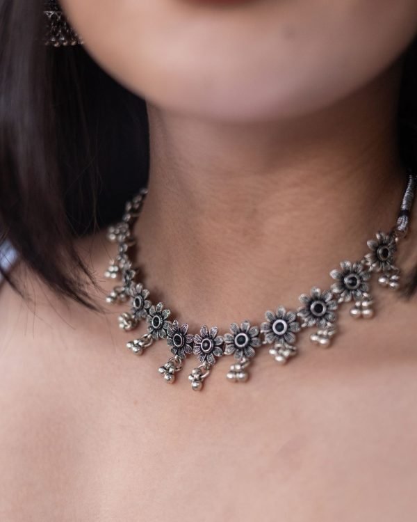 The choker sitting at the base of the neck